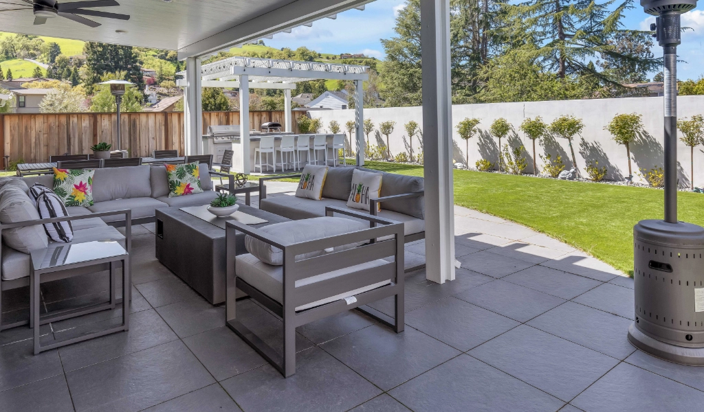 Backyard remodel with outdoor couches and coffee table.