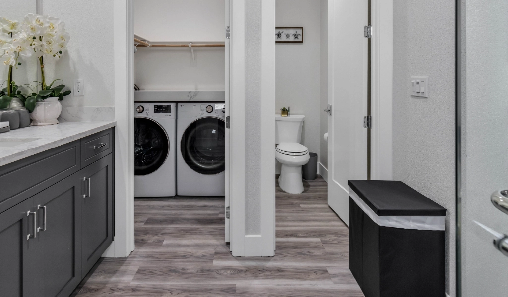 ADU with laundry machines and small bathroom.