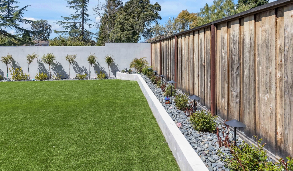 Backyard remodel with wooden fence.
