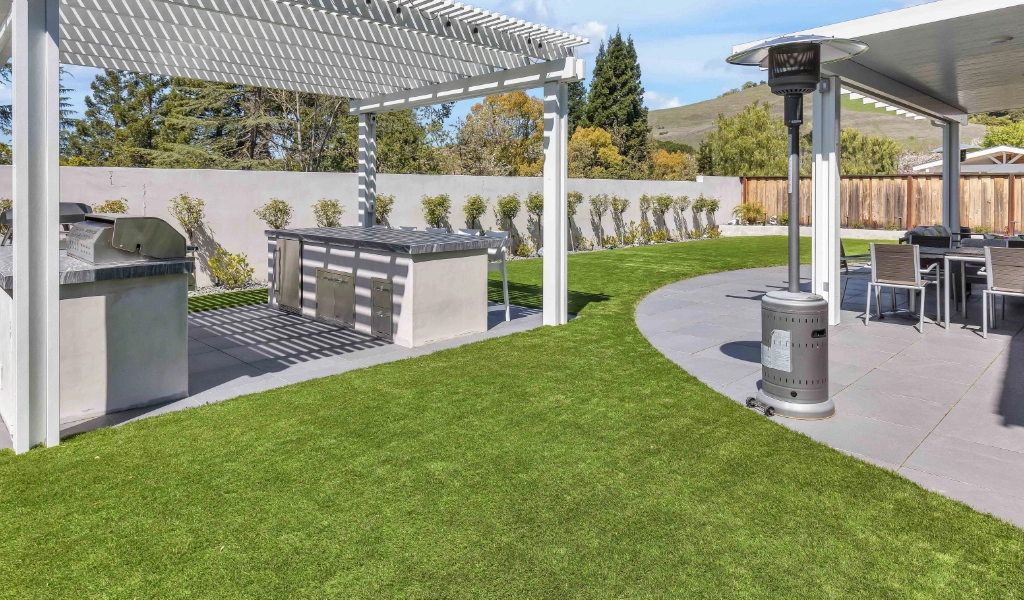 Backyard remodel with outdoor tables and heater.