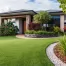contemporary home outdoor landscaping with artificial grass, lush greenery and mulch