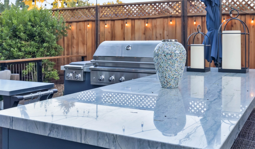 a relaxing and modern backyard living space and outdoor kitchen remodel with outdoor furniture and fireplace