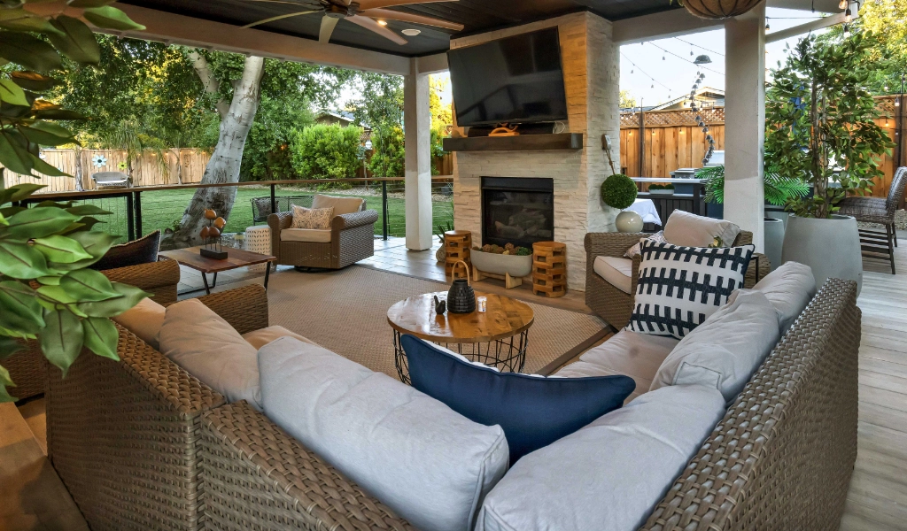 a relaxing and modern outdoor and backyard living space remodel with outdoor furniture and fireplace