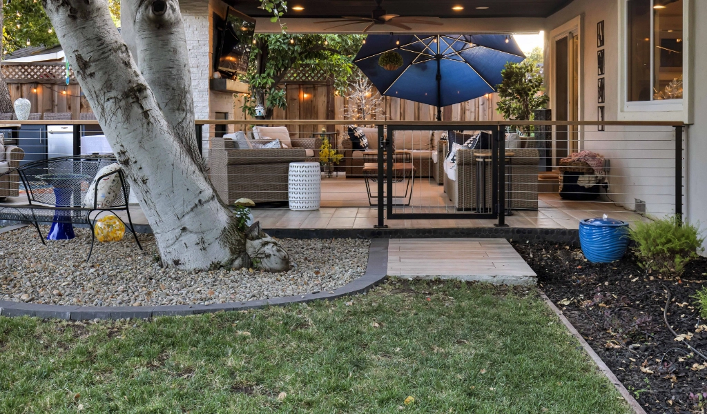 a relaxing and modern outdoor and backyard living space remodel with gate and paved walkway