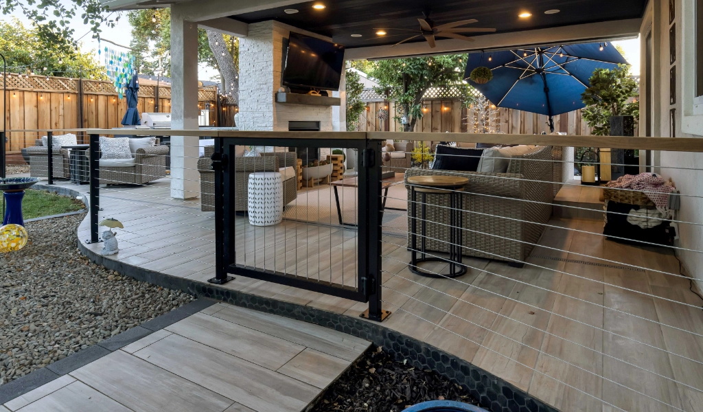 a relaxing and modern outdoor and backyard living space remodel with gate and paved walkway