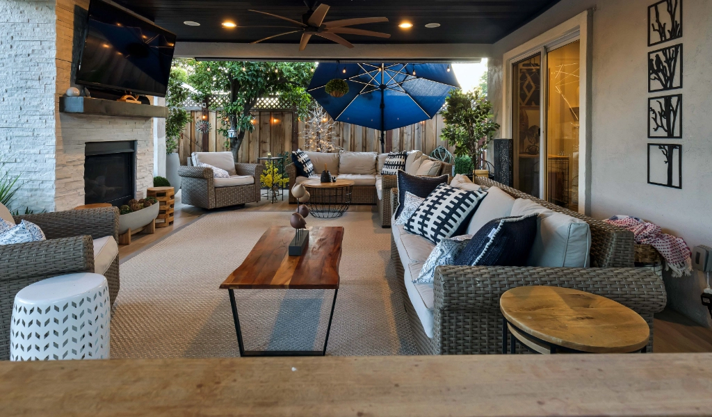 a relaxing and modern outdoor and backyard living space remodel with outdoor furniture and fireplace