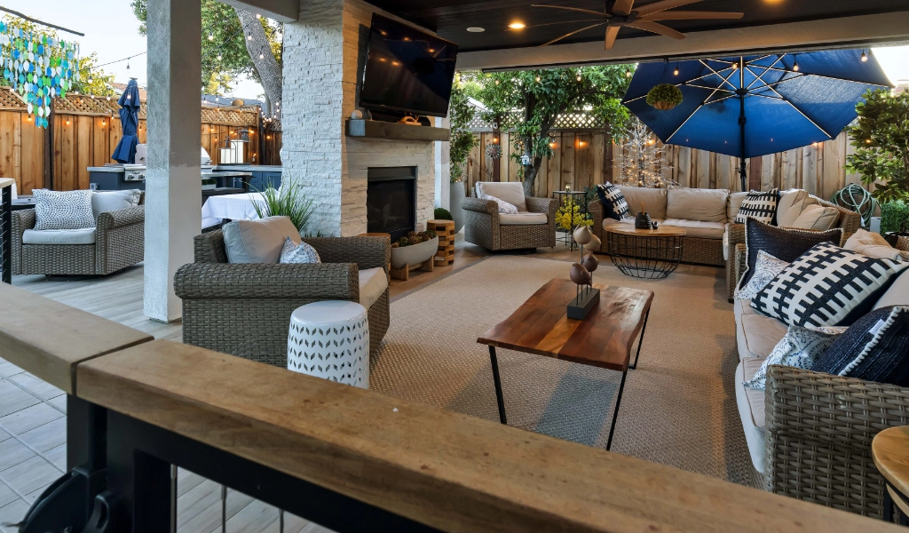 a relaxing and modern outdoor and backyard living space remodel with outdoor furniture and fireplace