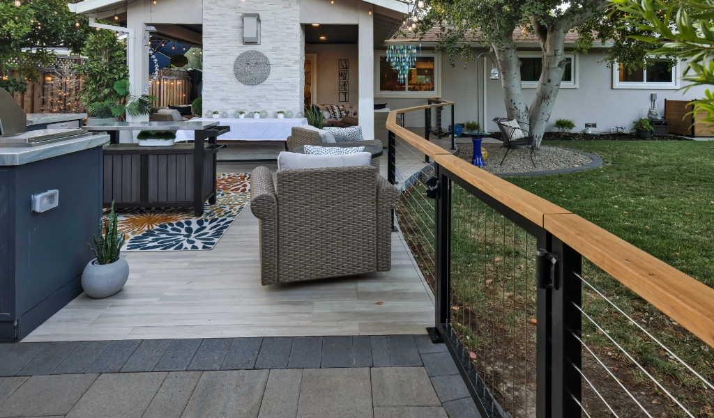 a relaxing and modern backyard living space and outdoor kitchen remodel with outdoor furniture