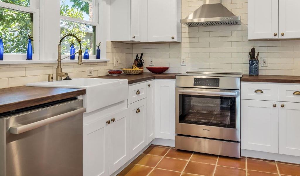 a transformative kitchen remodel with Clay Tiles, Wooden Butcher Countertops, and White Cabinets