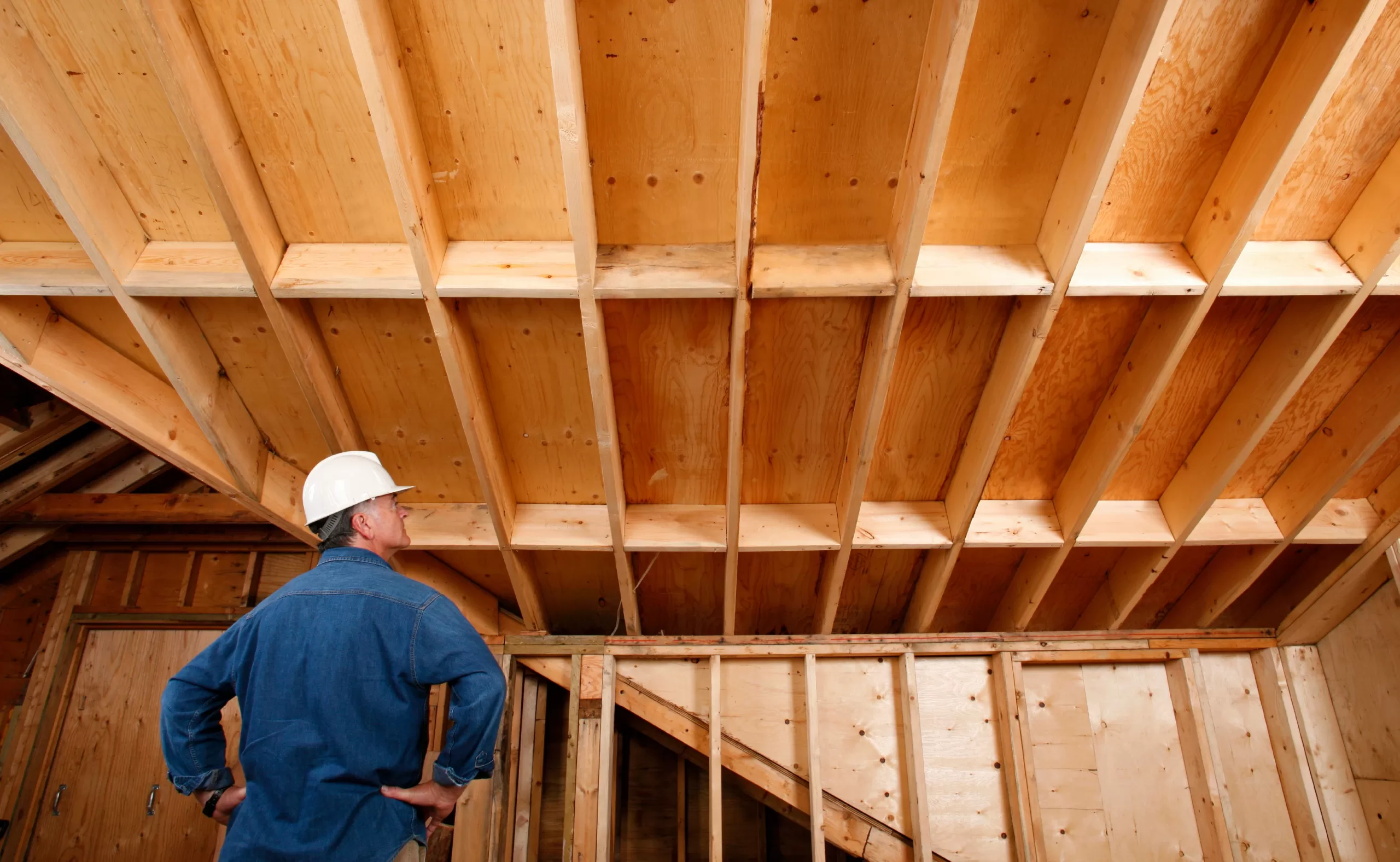 Contractor inspecting construction work of a home addition during a house remodel