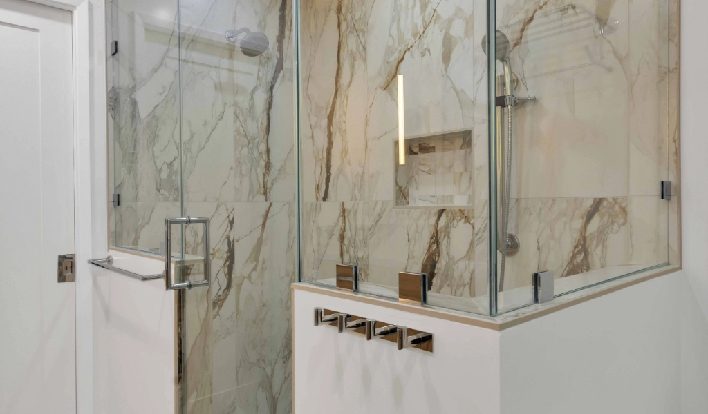 a new and elegant master bathroom remodel featuring porcelain tiles with dramatic marble veining